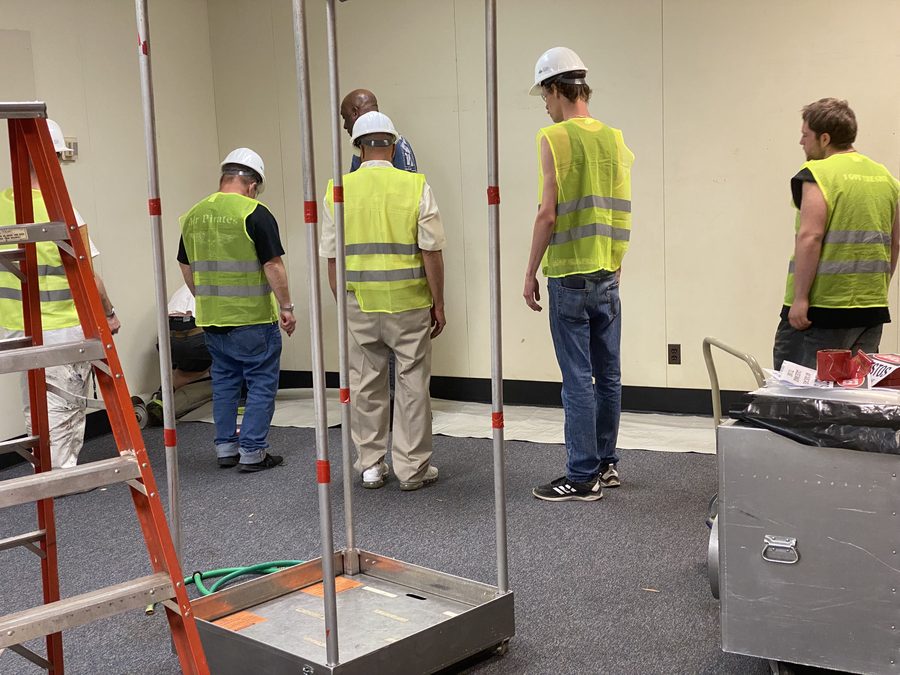 Building the decontamination chamber frame inside a converted classroom.