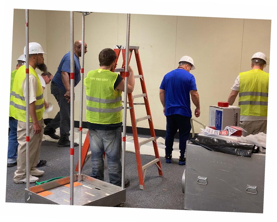 Framing the decon chamber and staging containment materials.