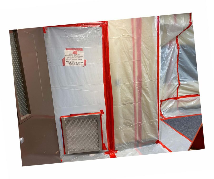 Critical barrier with the required respiratory-protection warning posted.