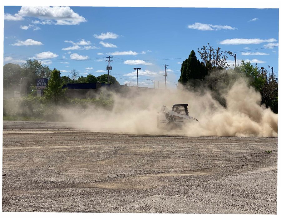 Apprentice running a skid-steer during asphalt and site-prep training at AC3.