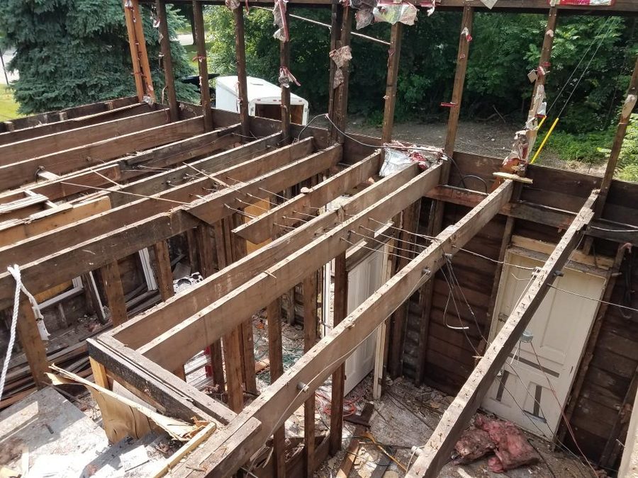 Framing and joists carefully removed piece by piece during deconstruction.