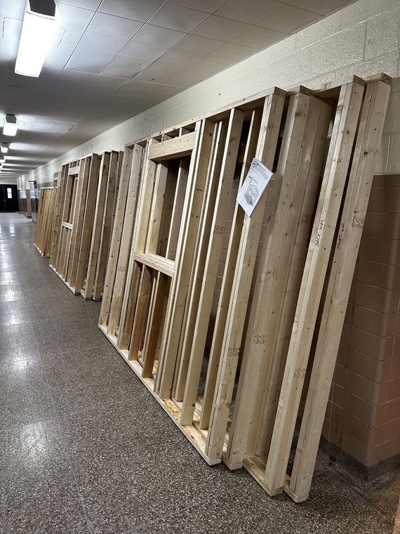Wall panels framed and labeled — Front Wall, Back Wall, Sides — staged in the AC3 hallway.