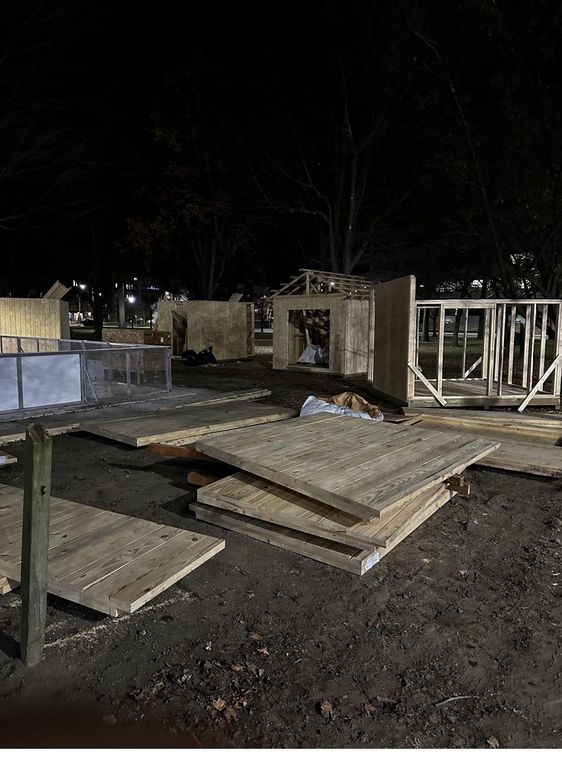 Assembling the market stalls as the light fades.
