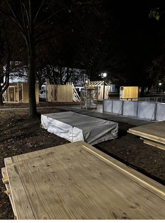 Panels staged and stalls going up after dark.